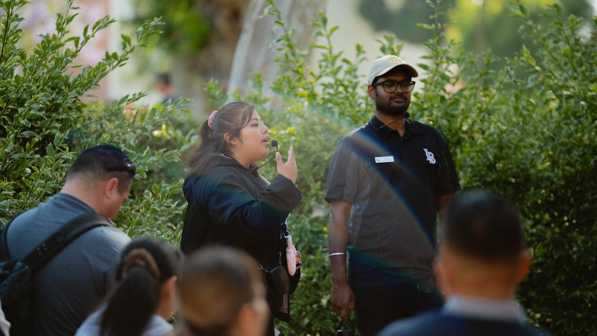 Student leader giving an orientation to people gathered around her.