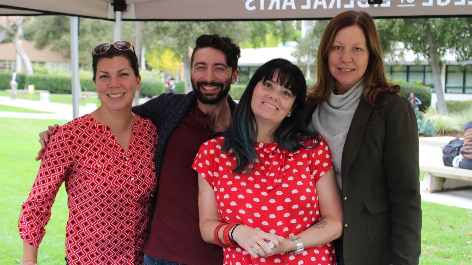CLA Dean, Deb Thien, smiling alongside three colleagues at CLA Day!