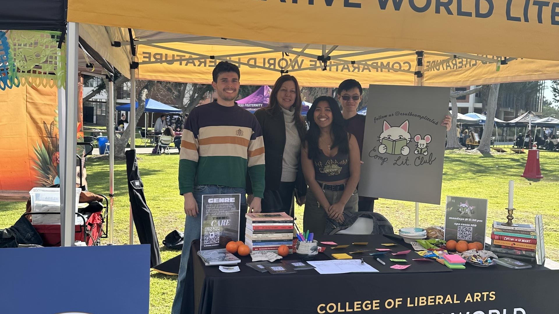 students and dean standing in booth