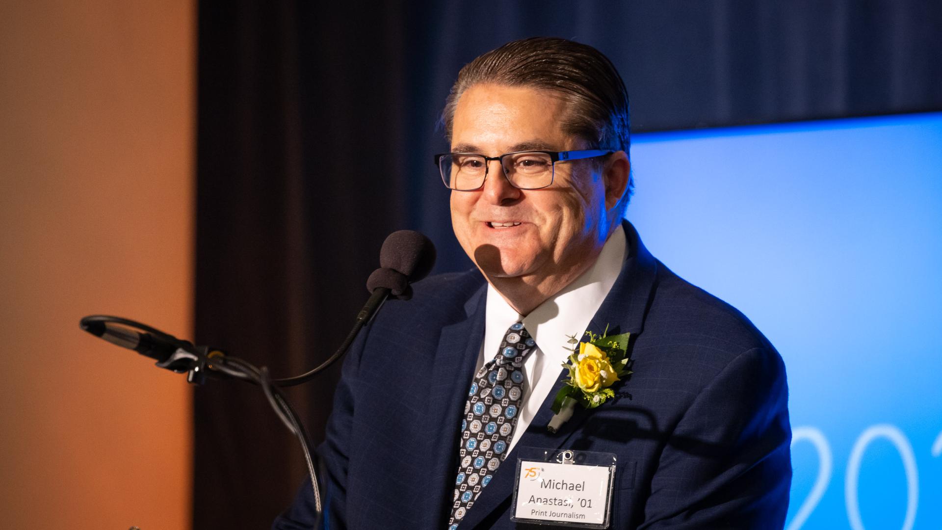 Distinguished Alumni honoree Michael Anastasi speaking at a podium