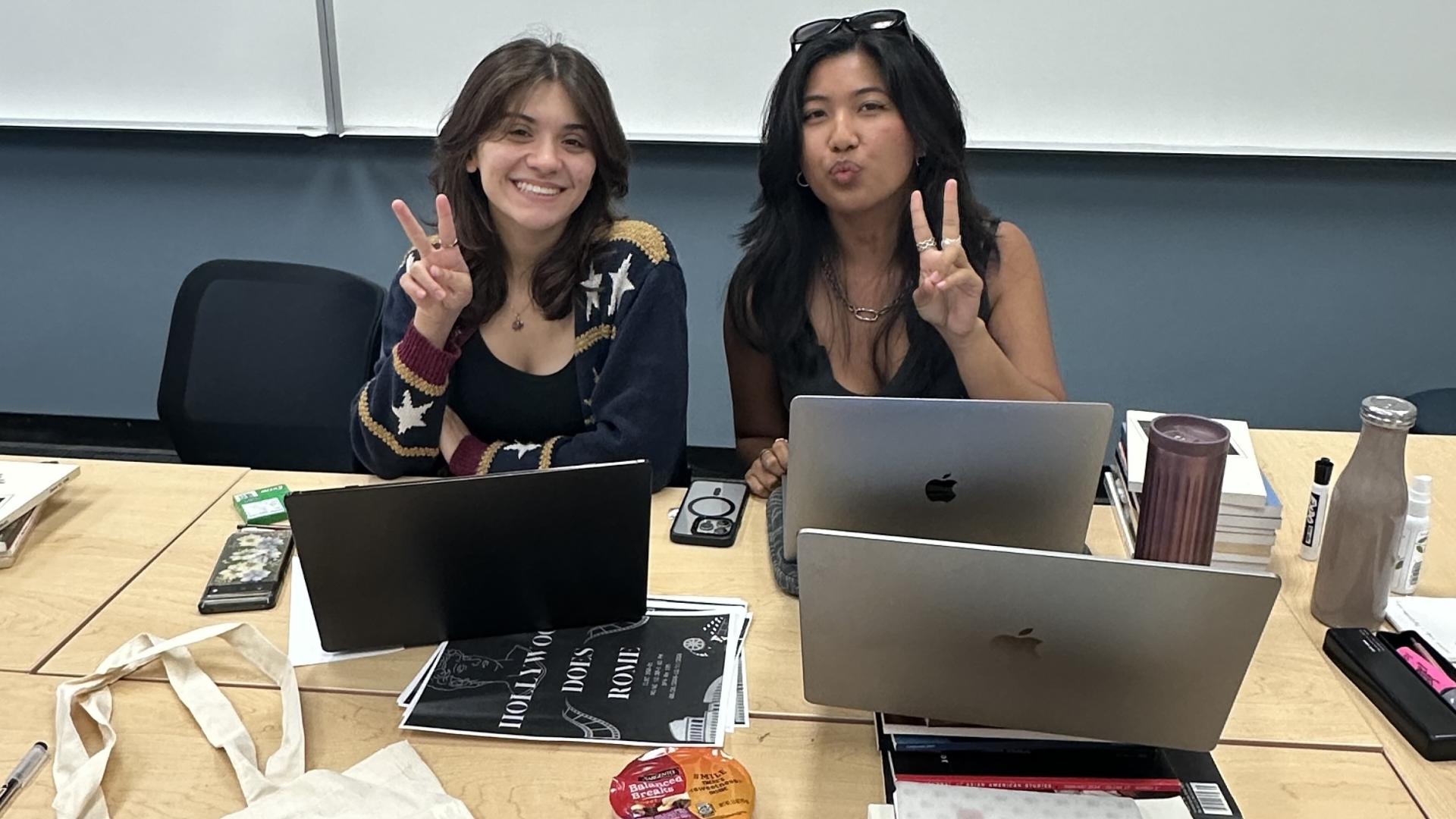 students sitting at table with computers