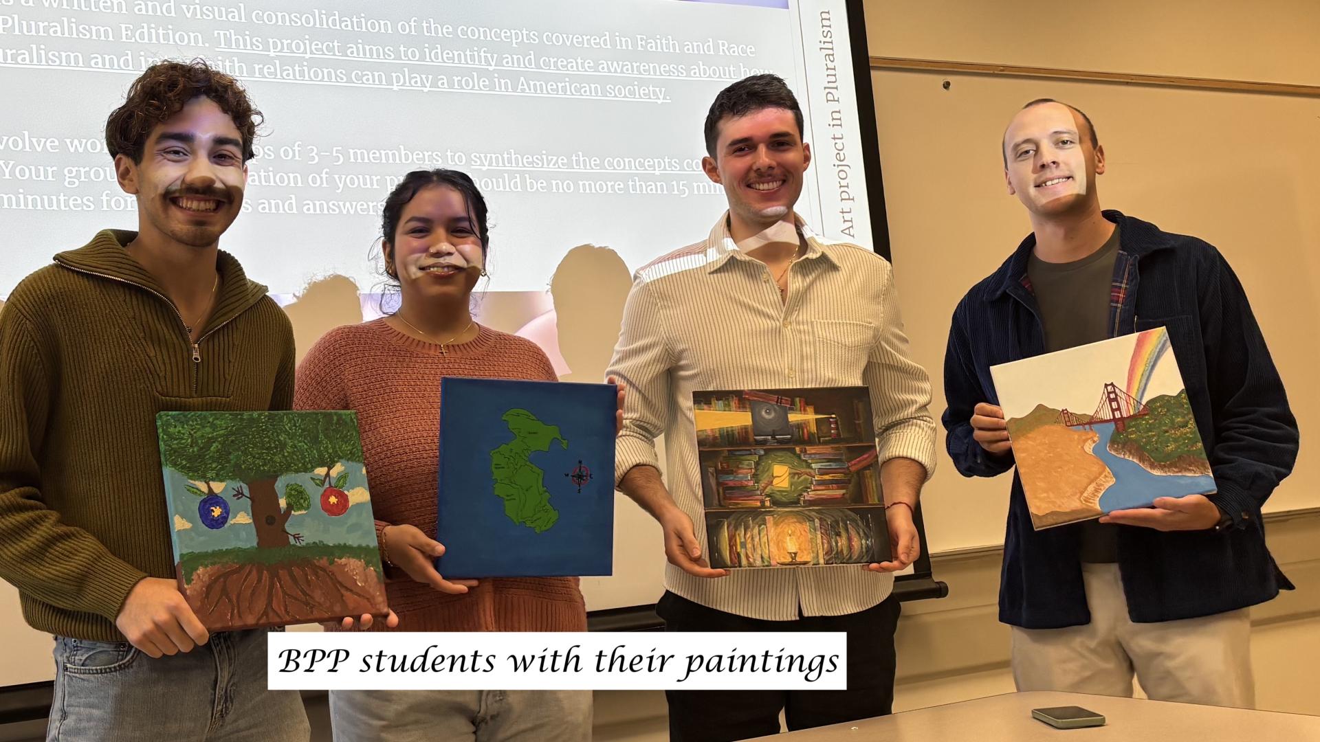 students holding paintings
