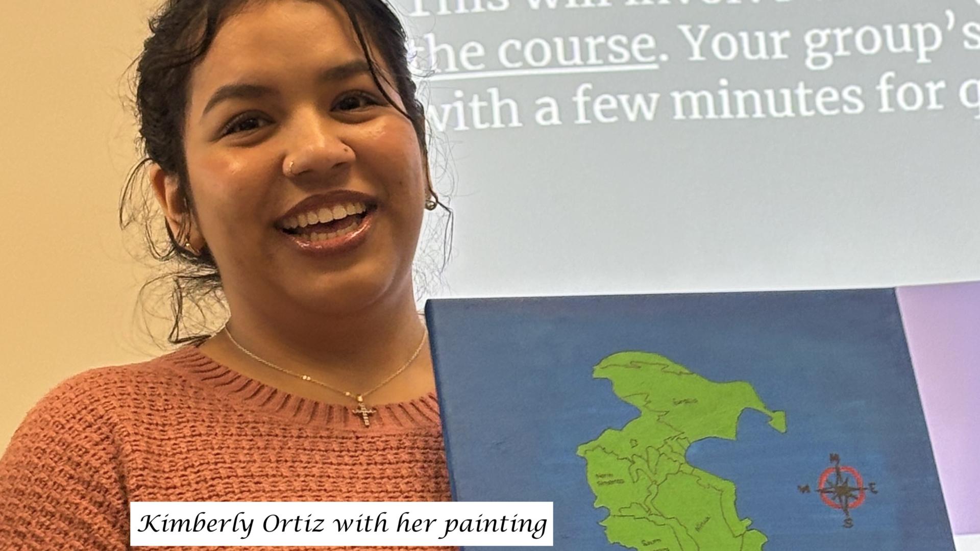 student holding painting