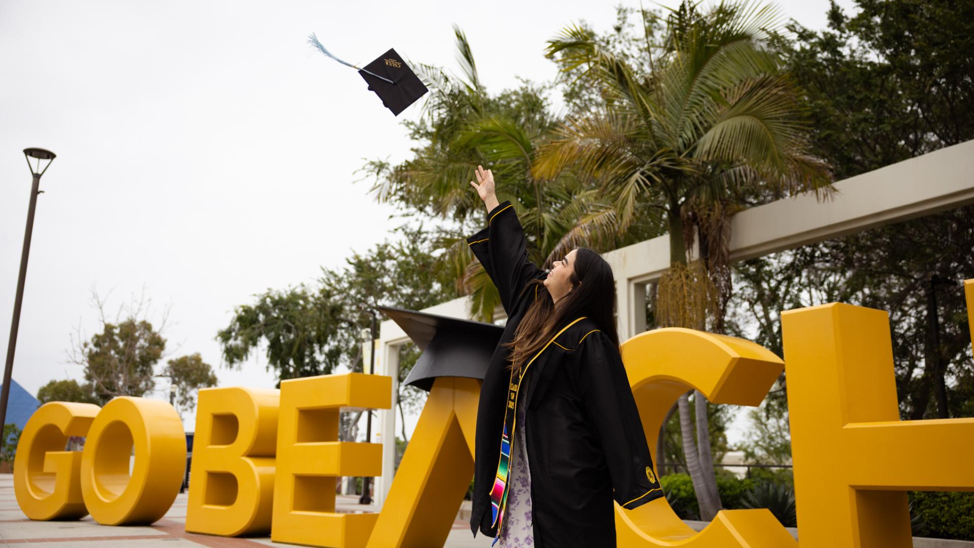 Student tossing graduation cap into the air
