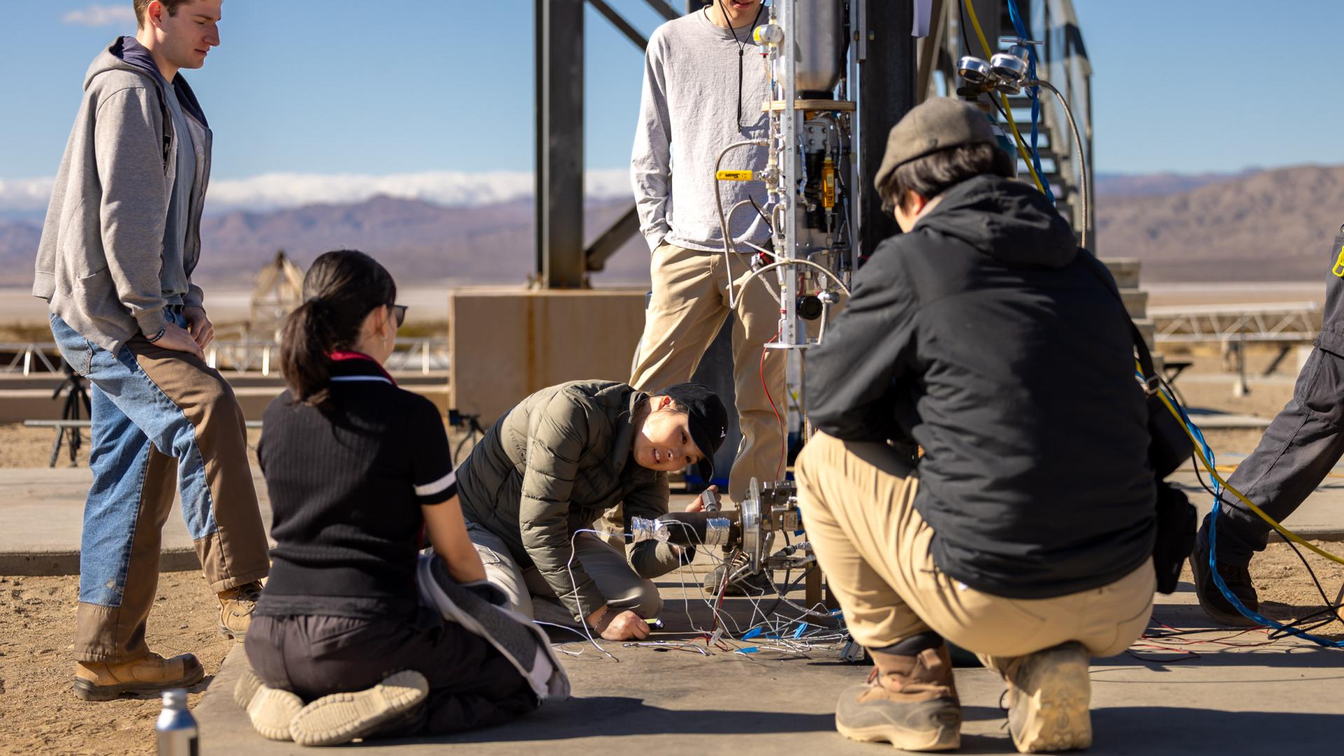 CSULB students work on a rocket testing apparatus in the desert