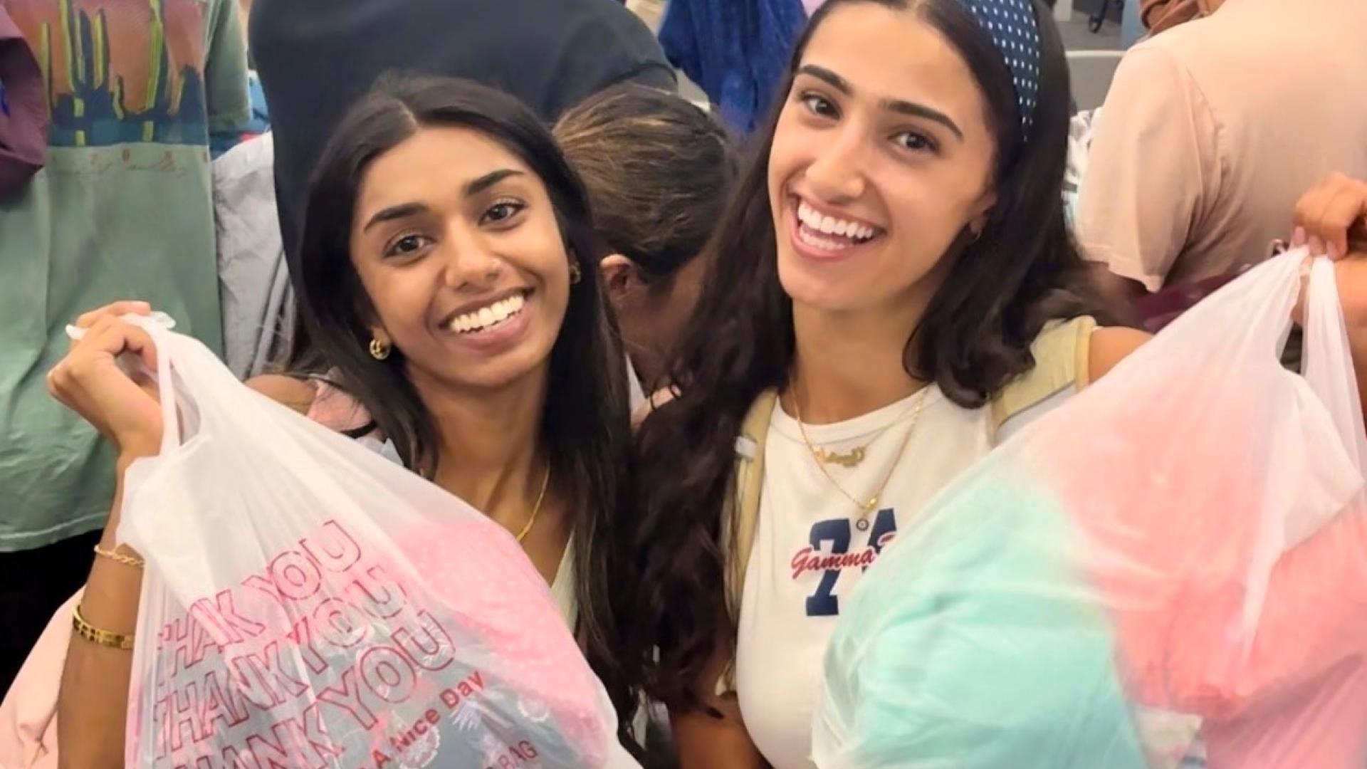 Two Students with bags of clothes from COB closet 2025