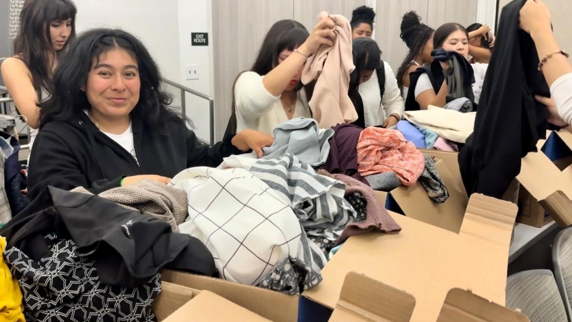 Female student looking at clothes at COB Closet