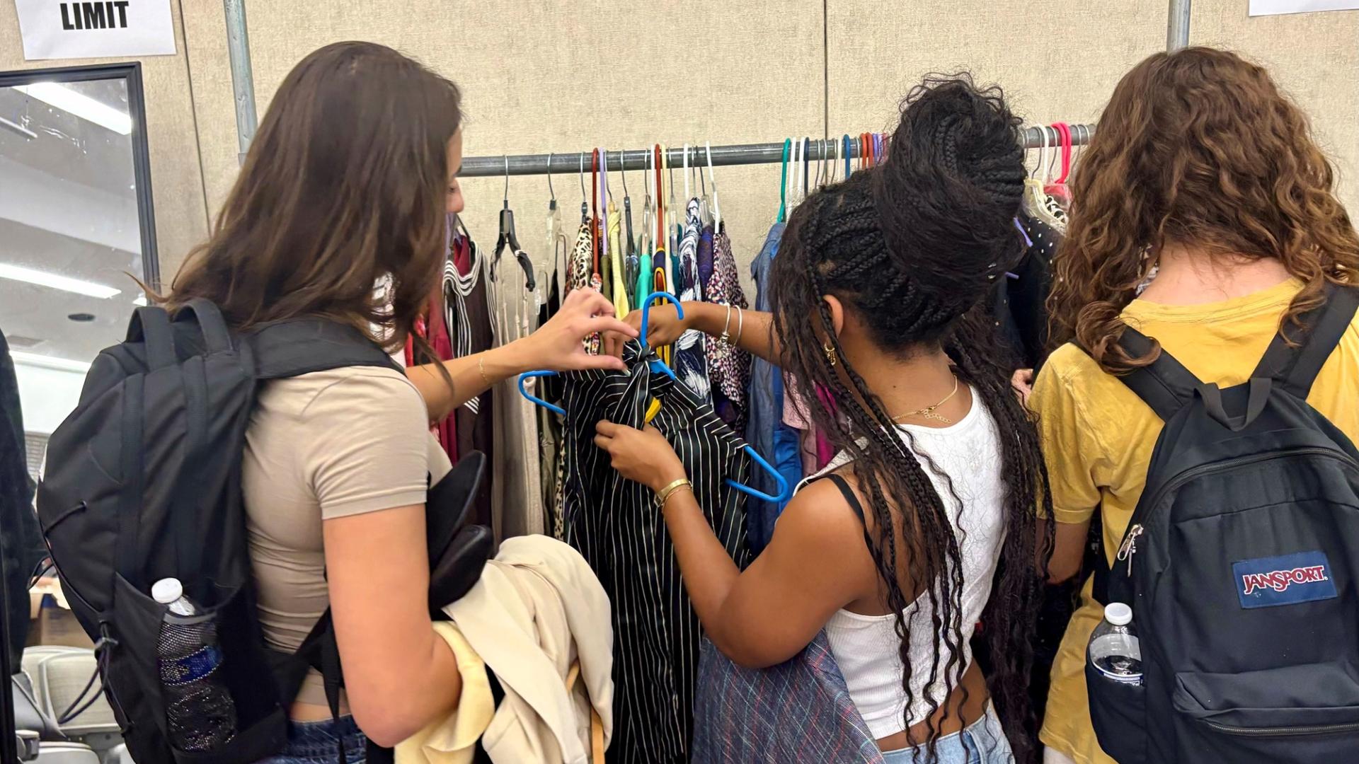 COB Closet Students looking at clothes mostly backs no faces