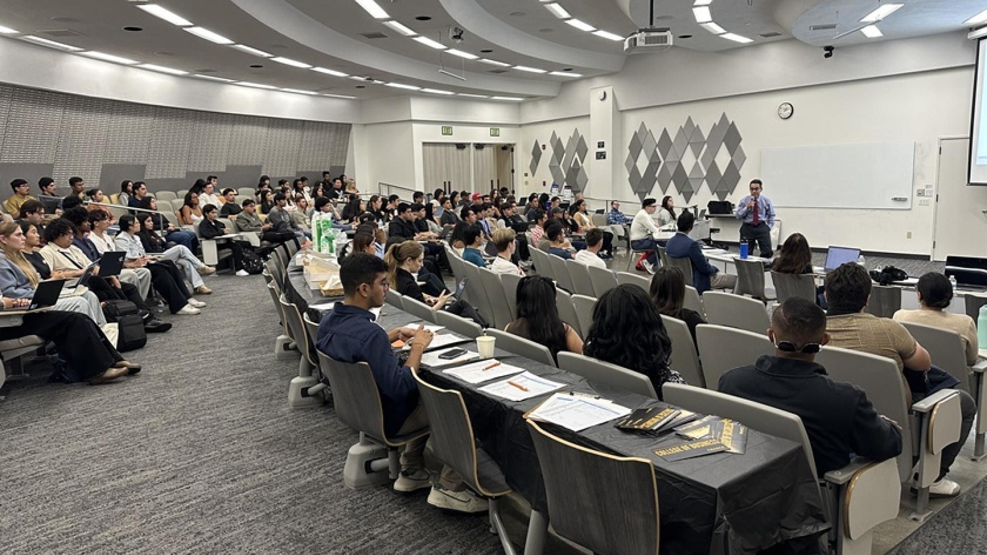 Students Beach Fin Rising presentation in a COB lecture hall