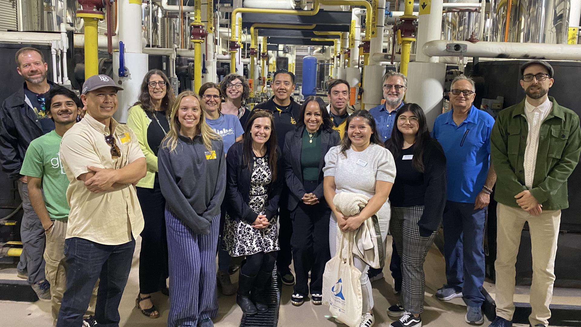A group of people standing in a heating and cooling plant
