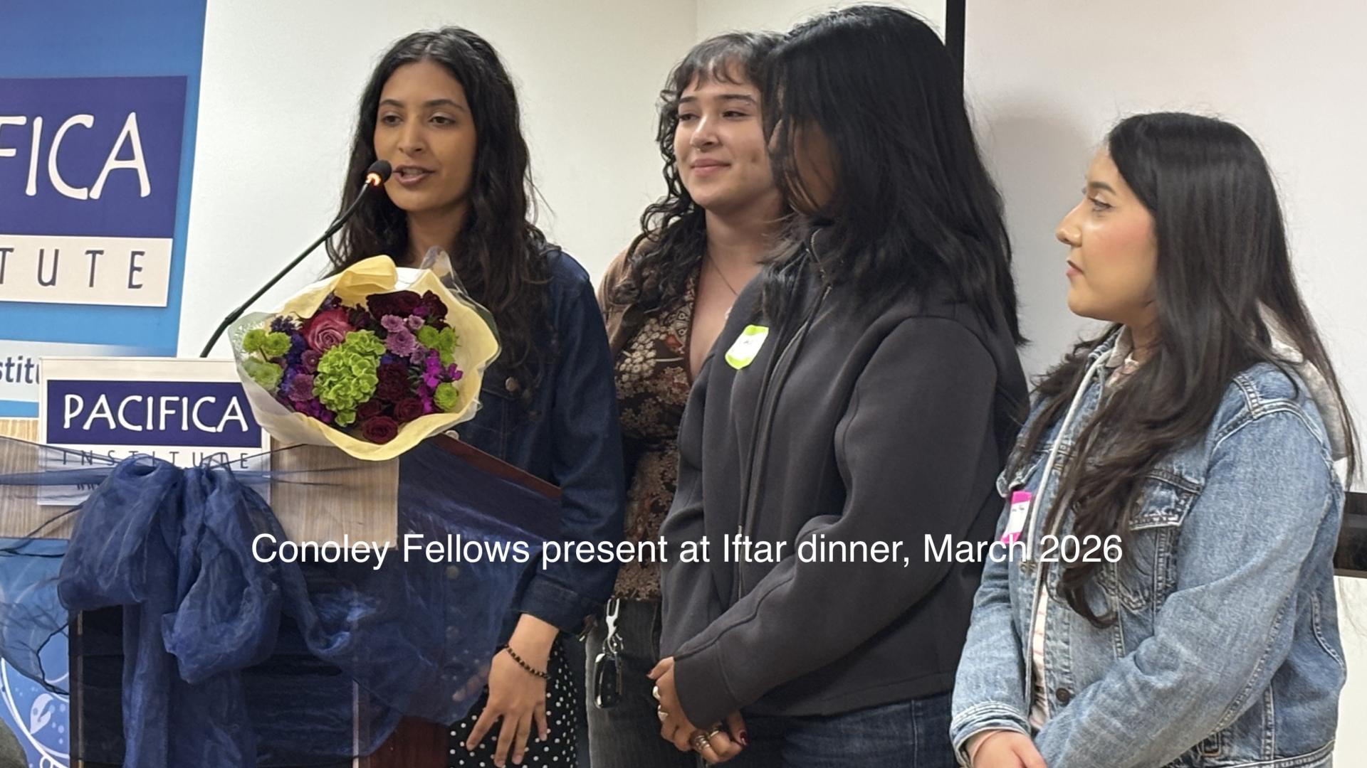 students talking behind podium