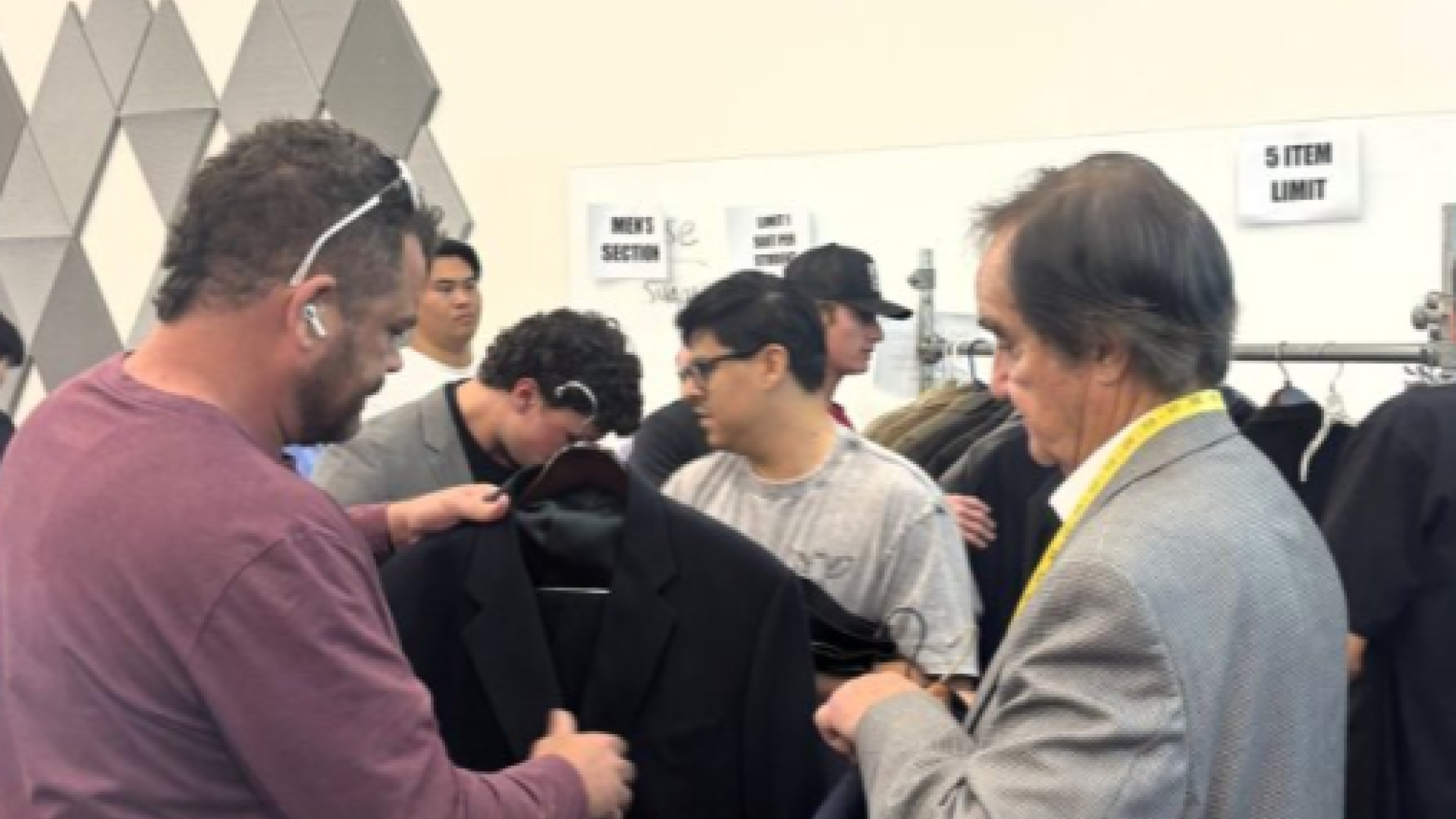 Volunteers helping students with clothes