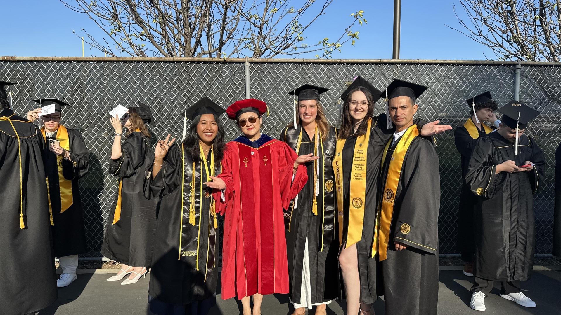 students and professor in regalia