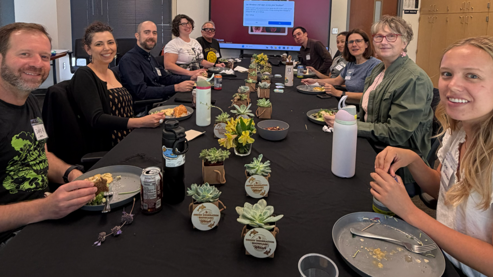 A group of people sitting around a table and eating food.