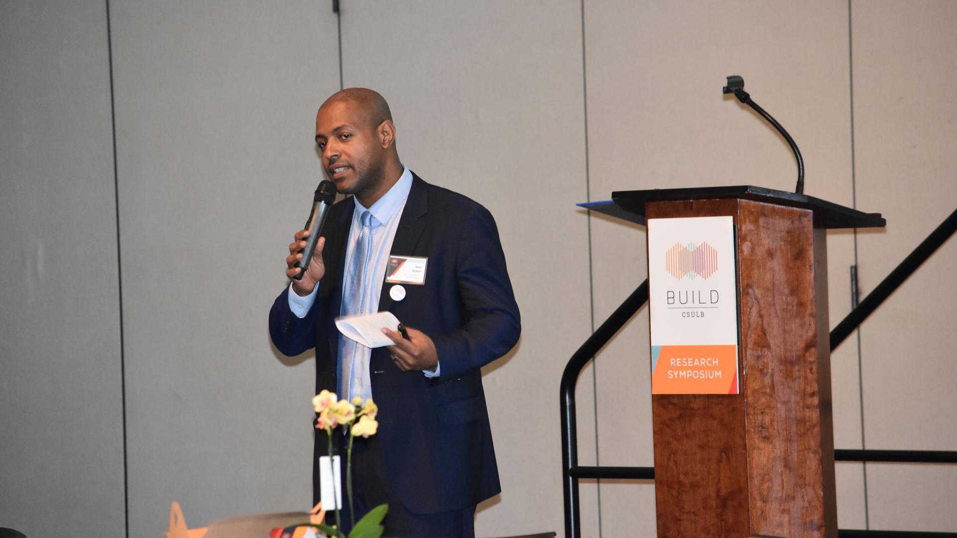 Dr. Malo Hutson speaking at the Annual Symposium Dr. Malo Hutson speaking at the Annual Symposium