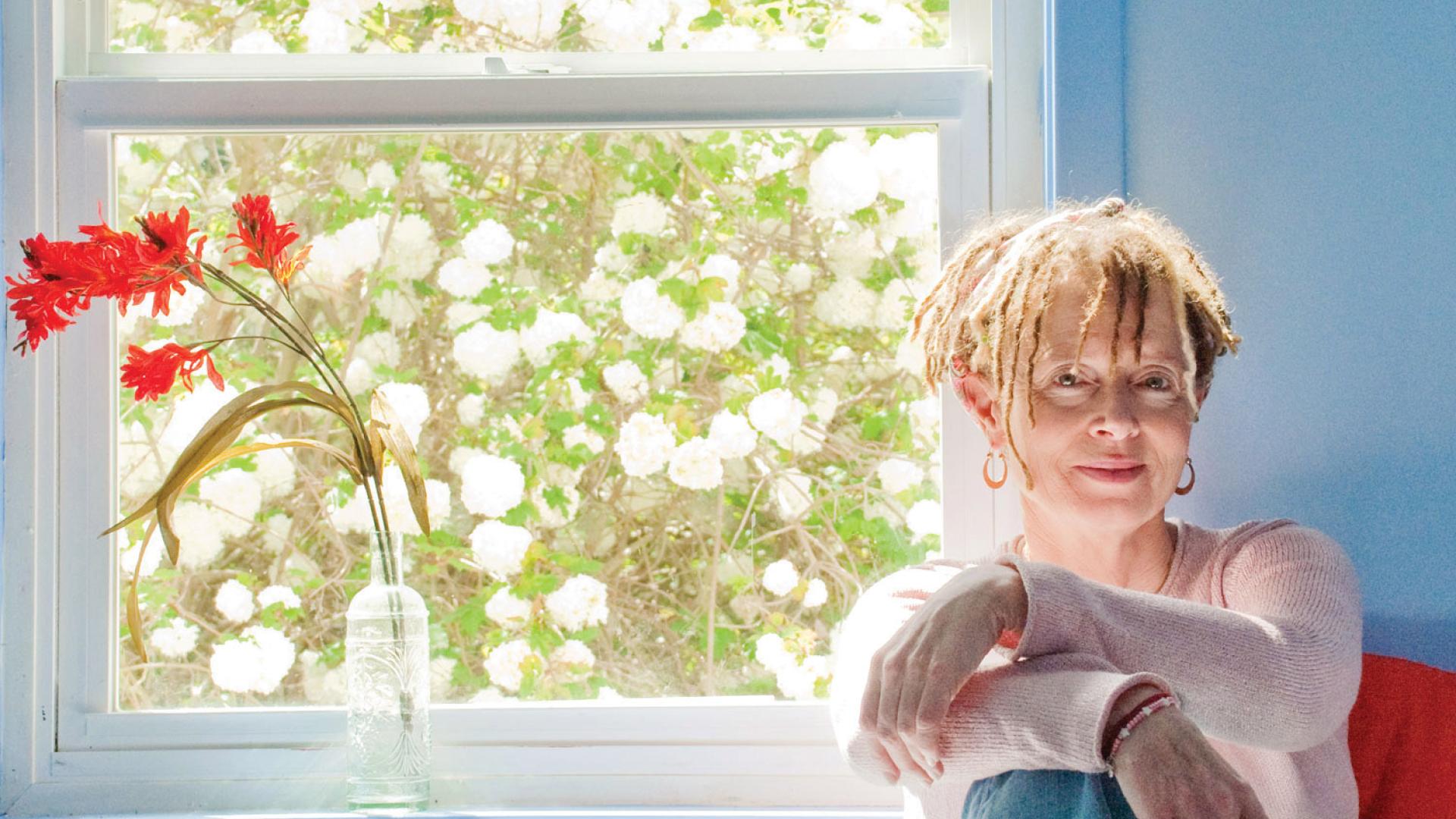 Author Anne Lamott sitting by window