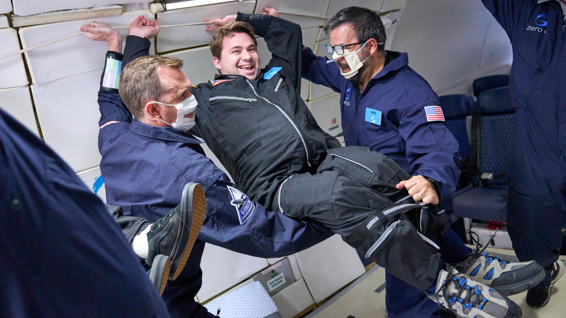 Two crew members help disabled man while floating in space (Photo: AstroAccess)