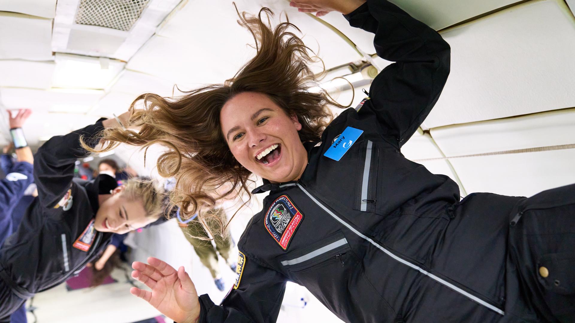 Two women laugh while floating in space (Photo: AstroAccess)