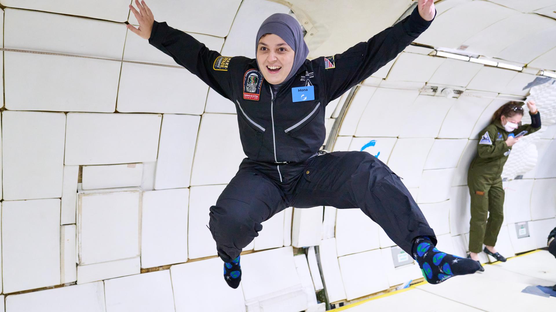 Woman wearing hijab floats in space (Photo: AstroAccess)