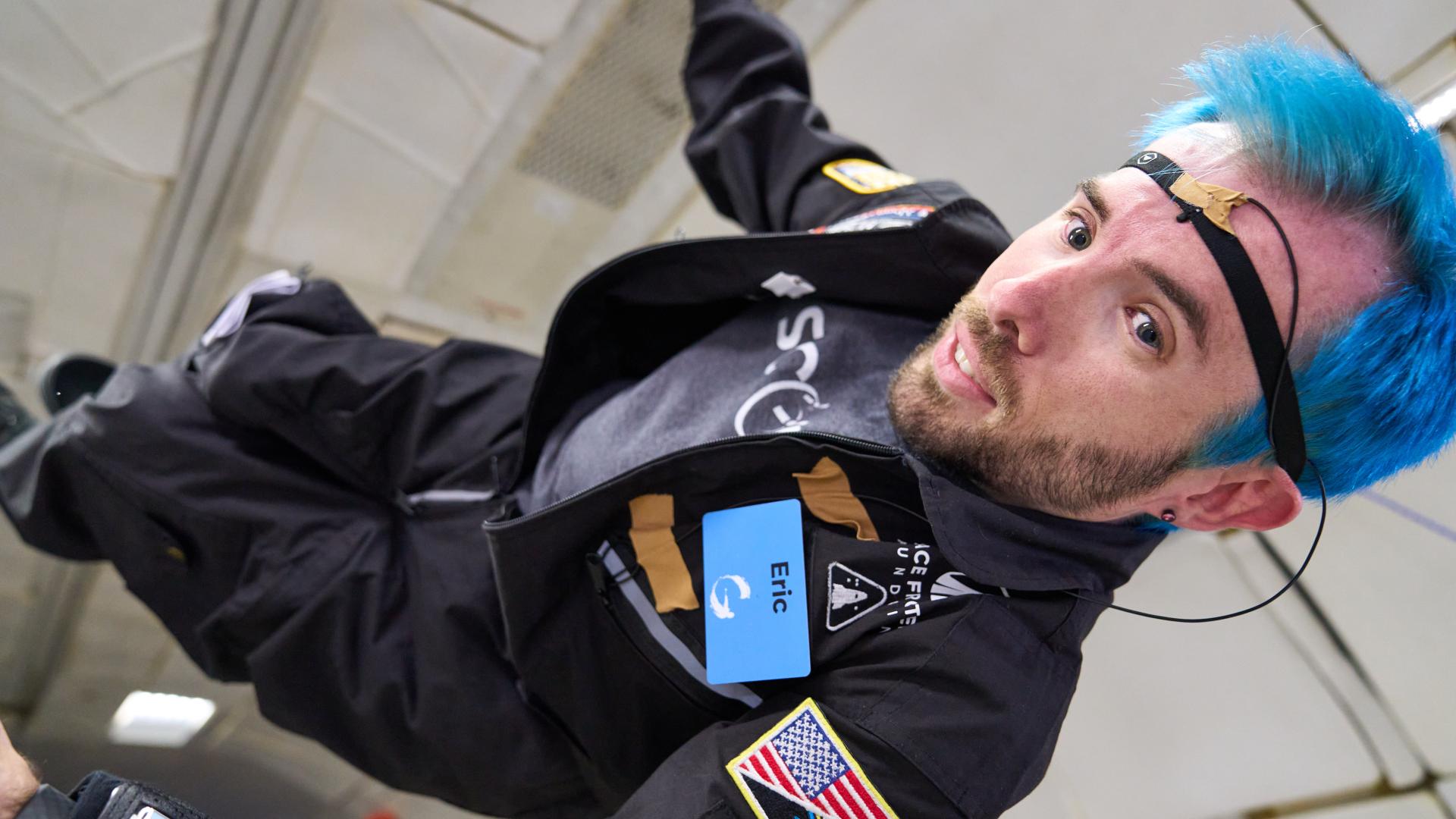 Man with blue hair flies sideways in space (Photo: AstroAccess)