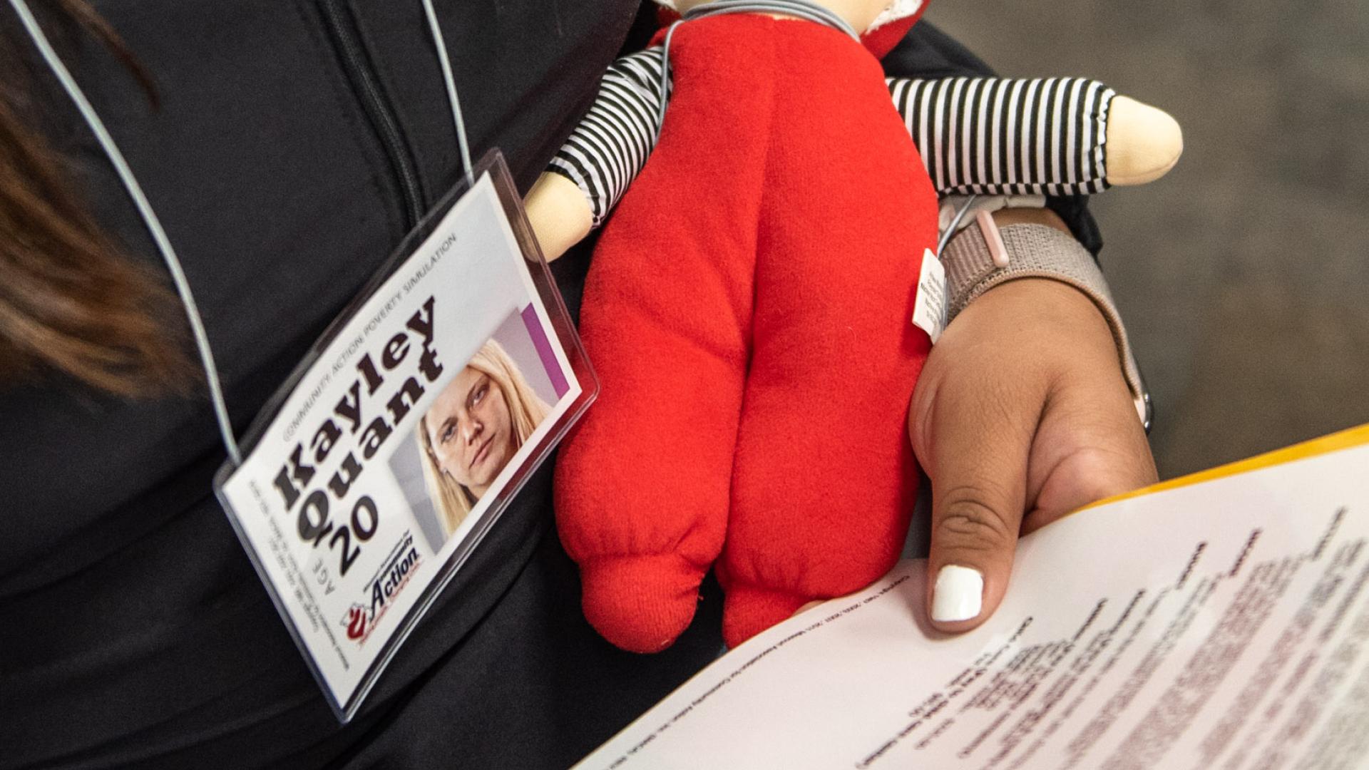 student holding doll