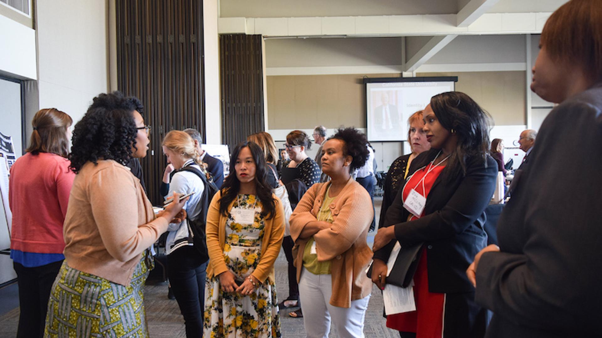 Students and Faculty Conversing at the Event