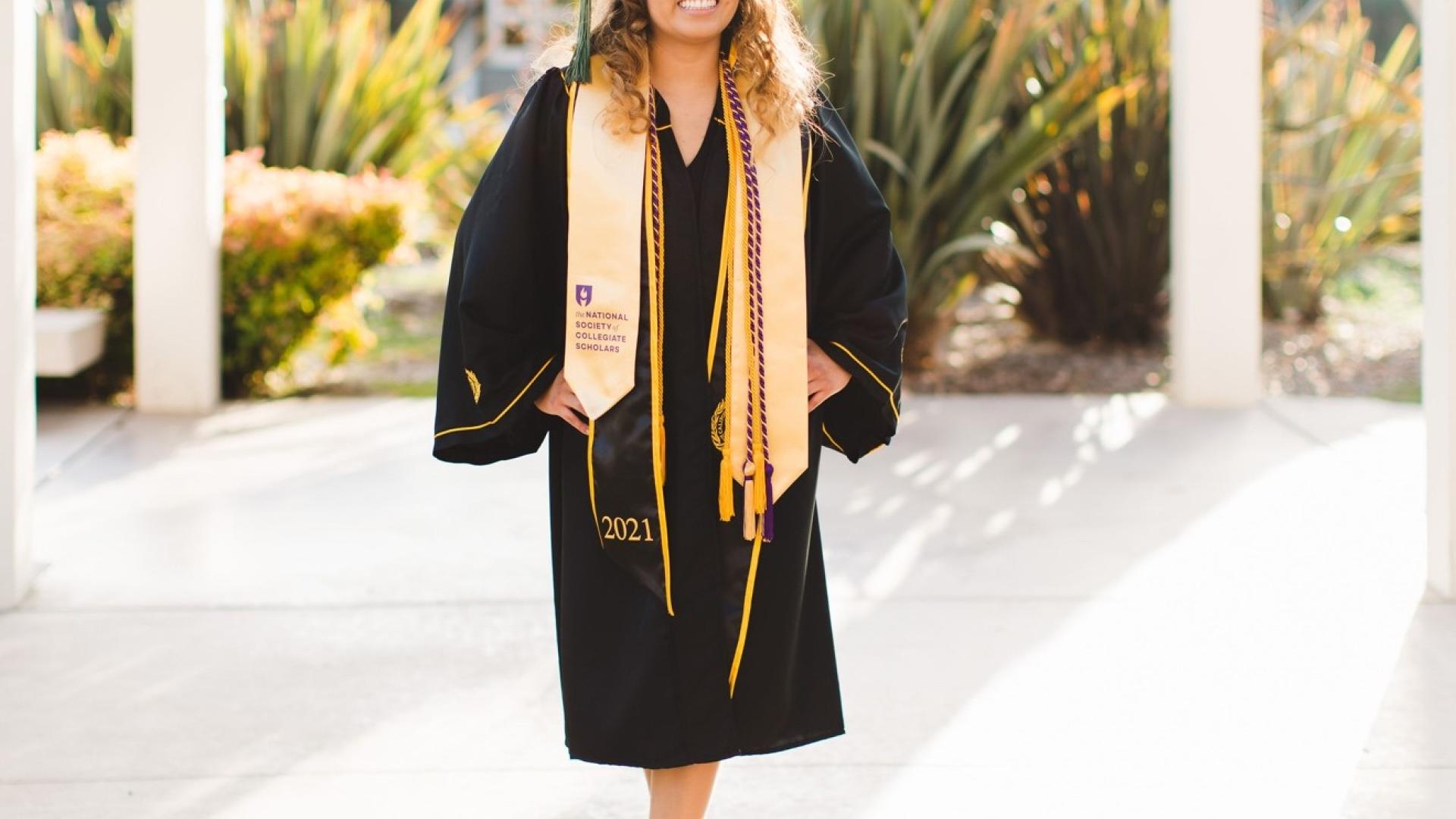 Gloria Hernandez in cap and gown on campus