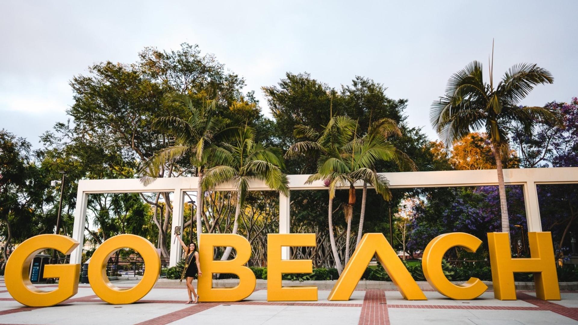 Gloria in front of Go Beach sign 