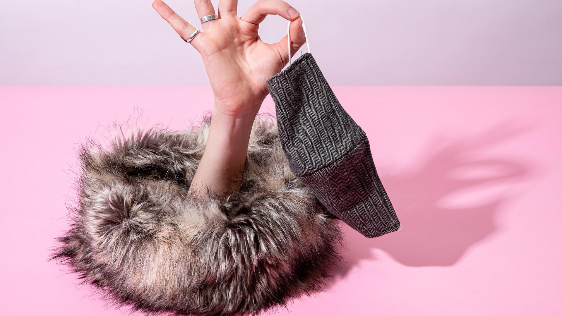 hand hold mask with fur around it hand hold mask with fur around it