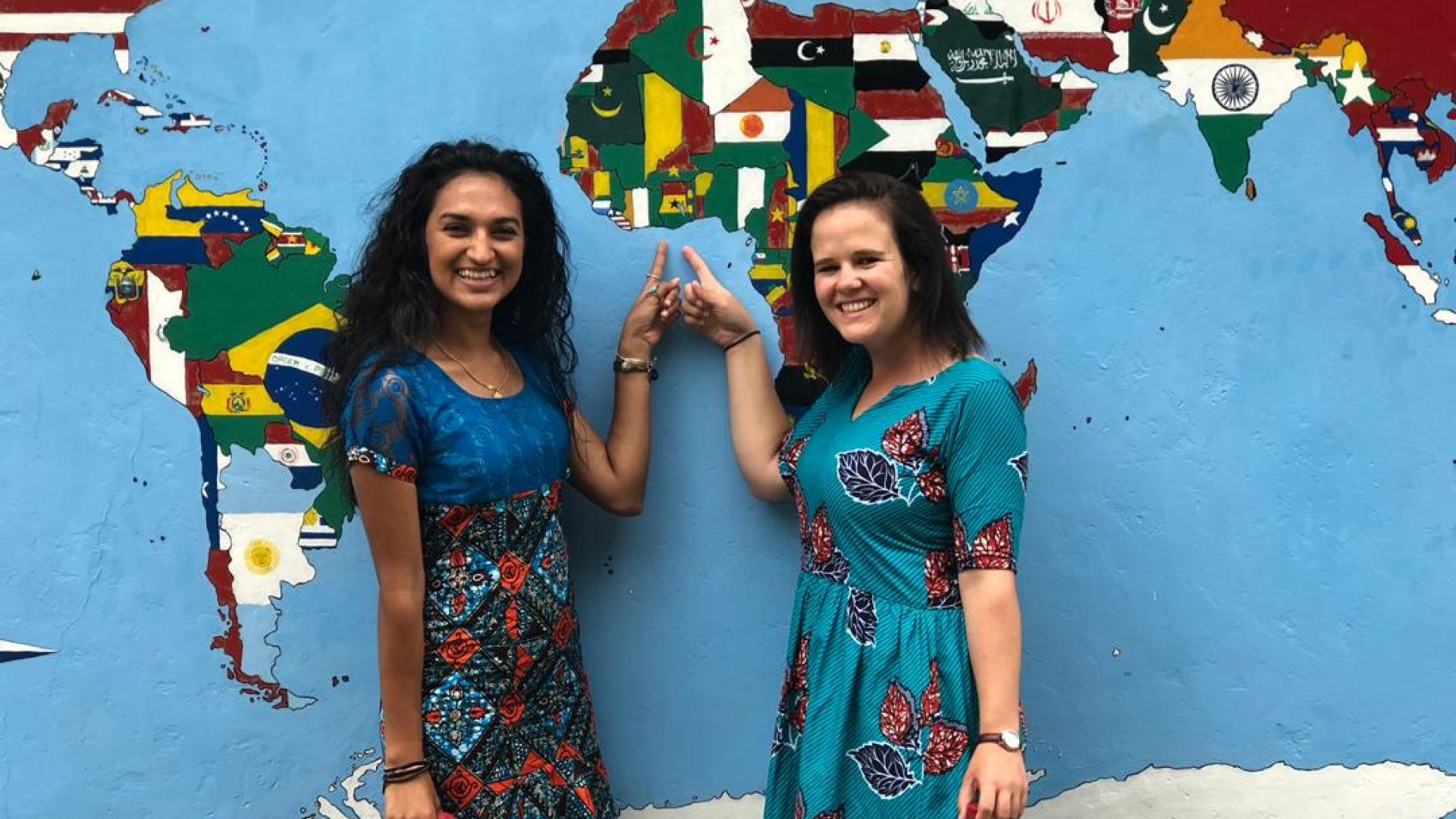 Peace Corps students in front of map Peace Corps students in front of map