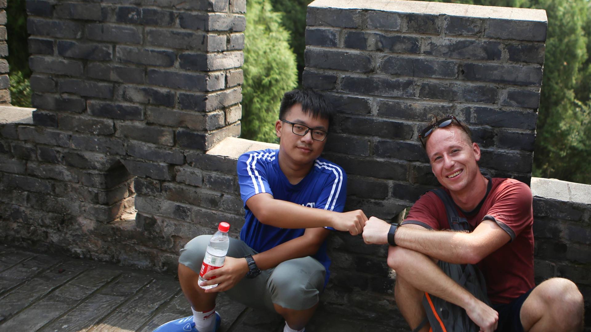 Peace Corps student fist bumps friend Peace Corps student fist bumps friend