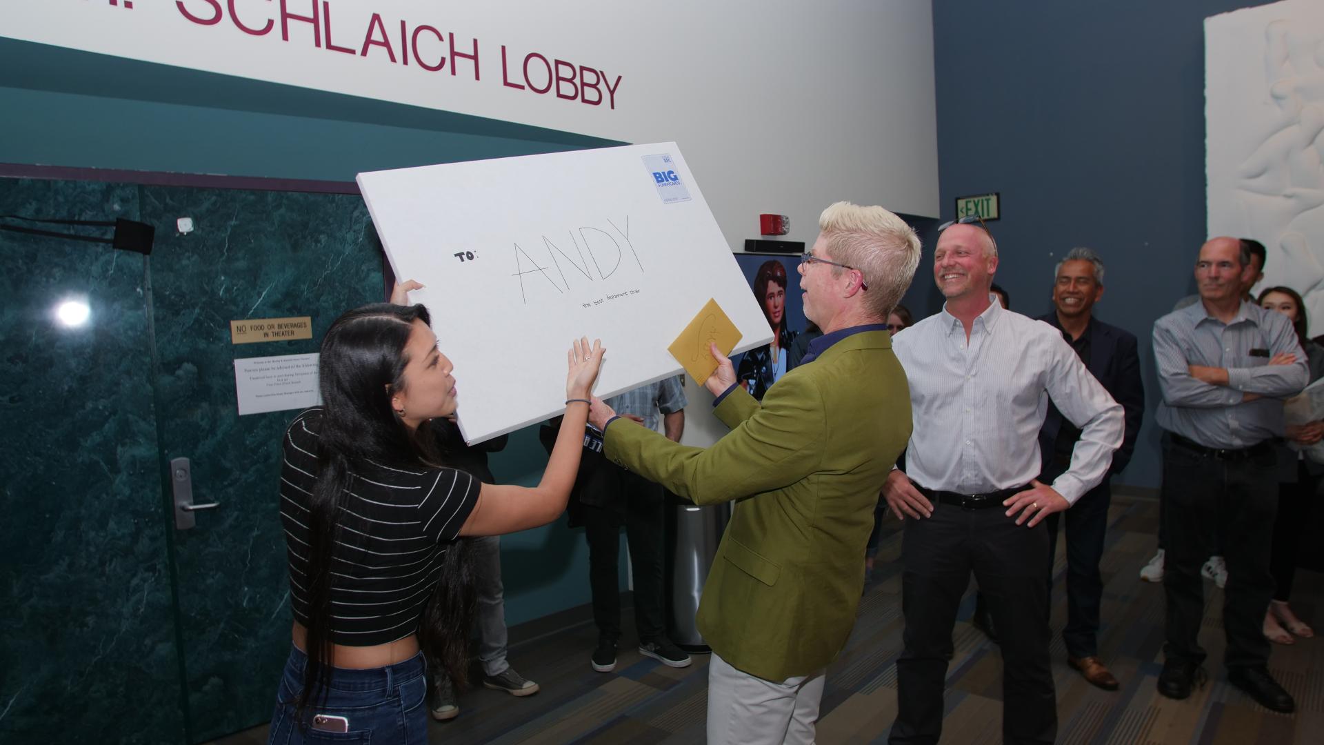 Student presents Andrew Vaca with an oversized Thank You card