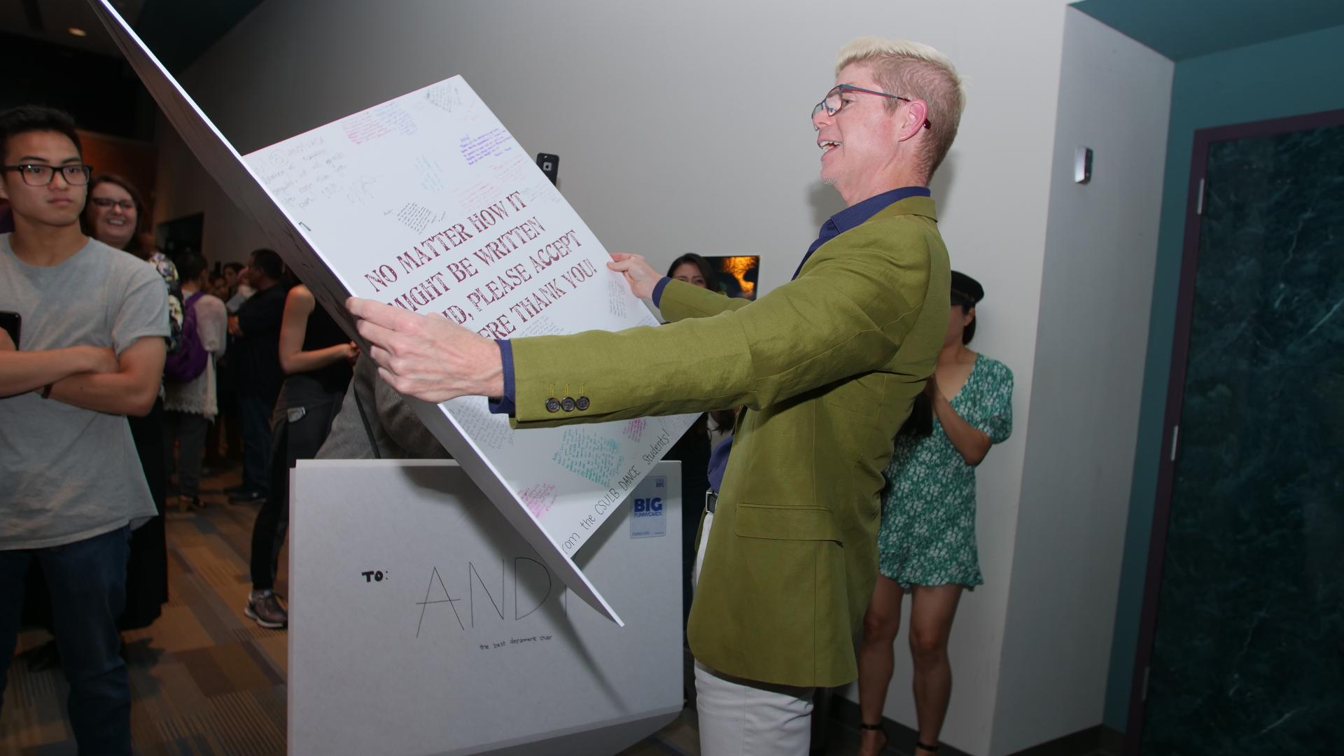 Andrew Vaca reads an oversized Thank You Card