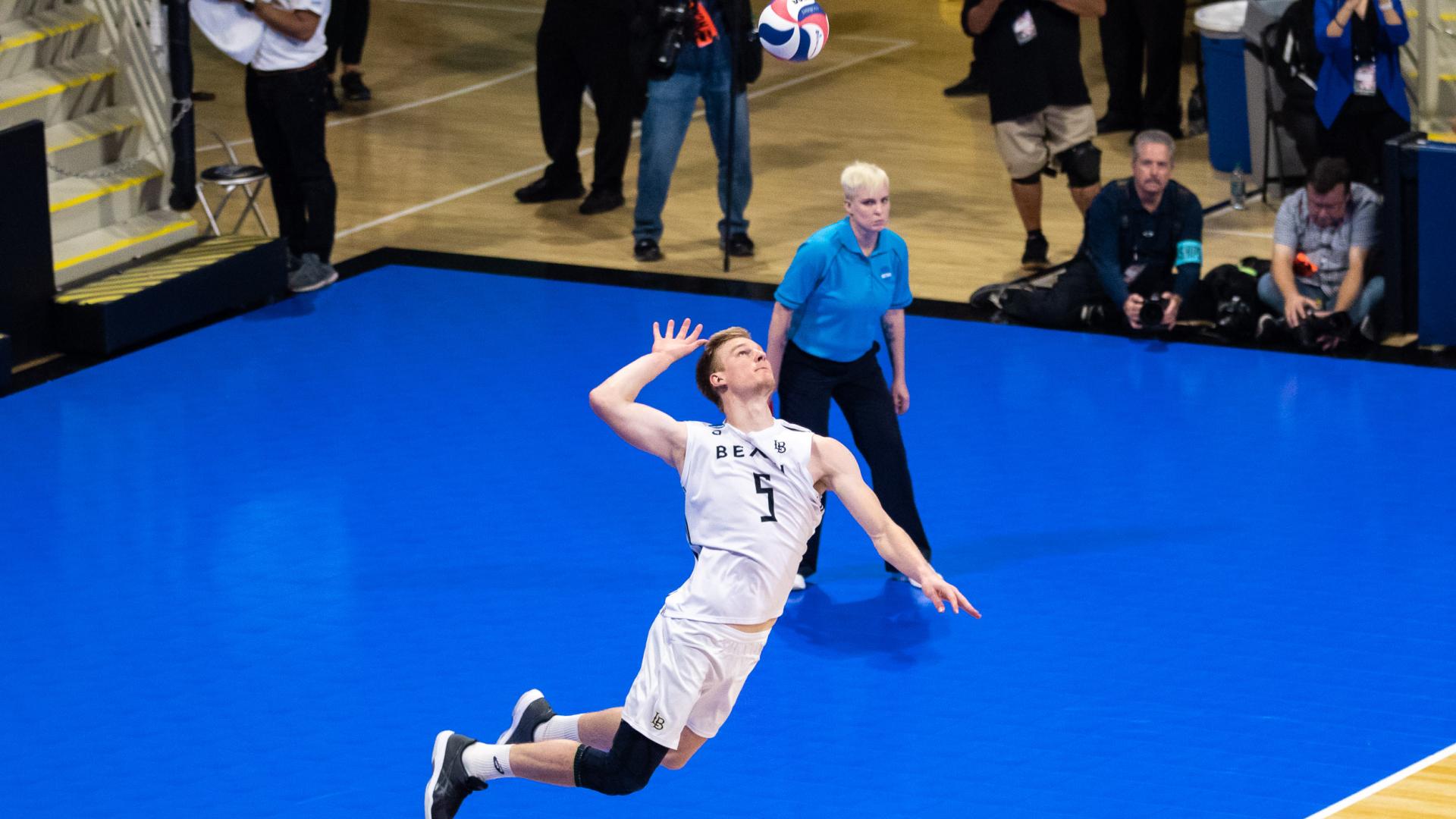 Kyle Ensing hits a volleyball