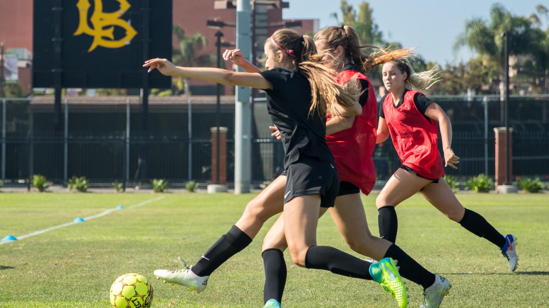 Soccer players battle during practice