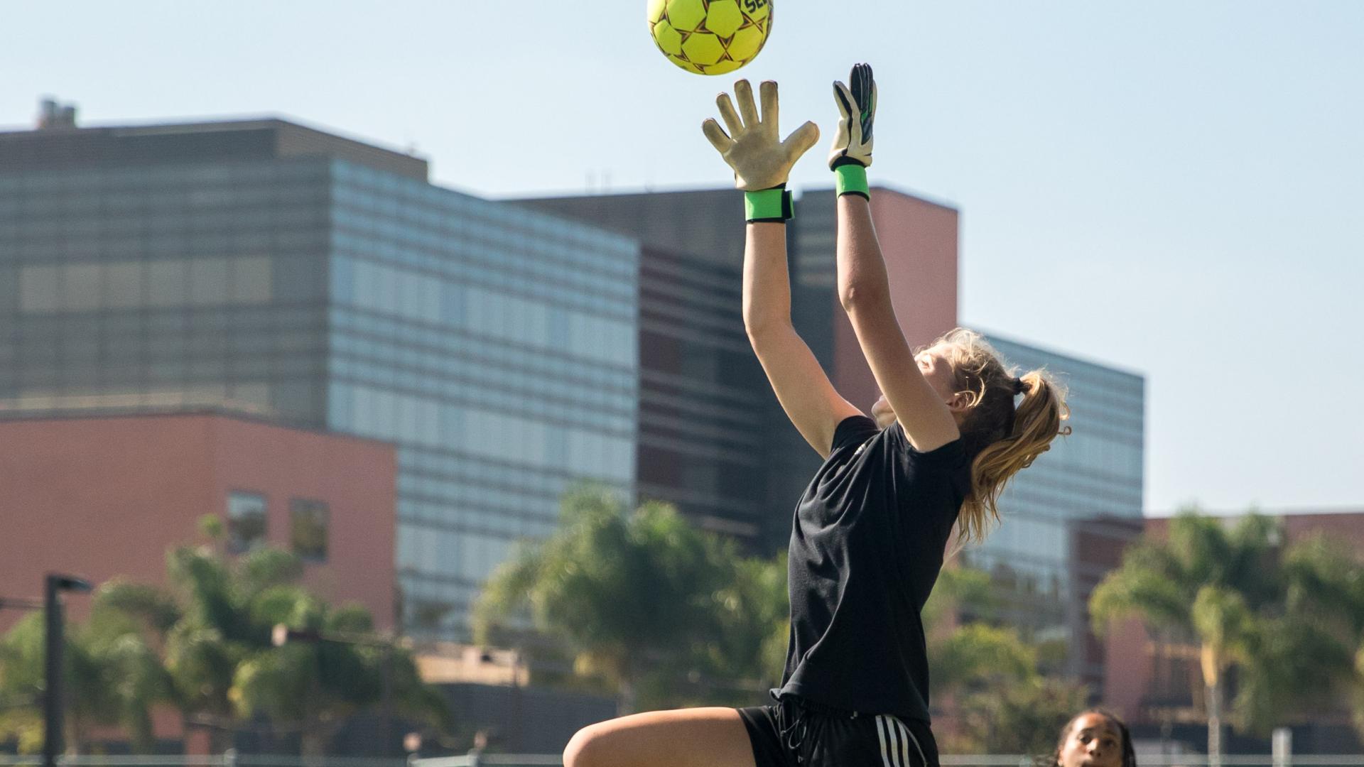 Soccer players battle during practice