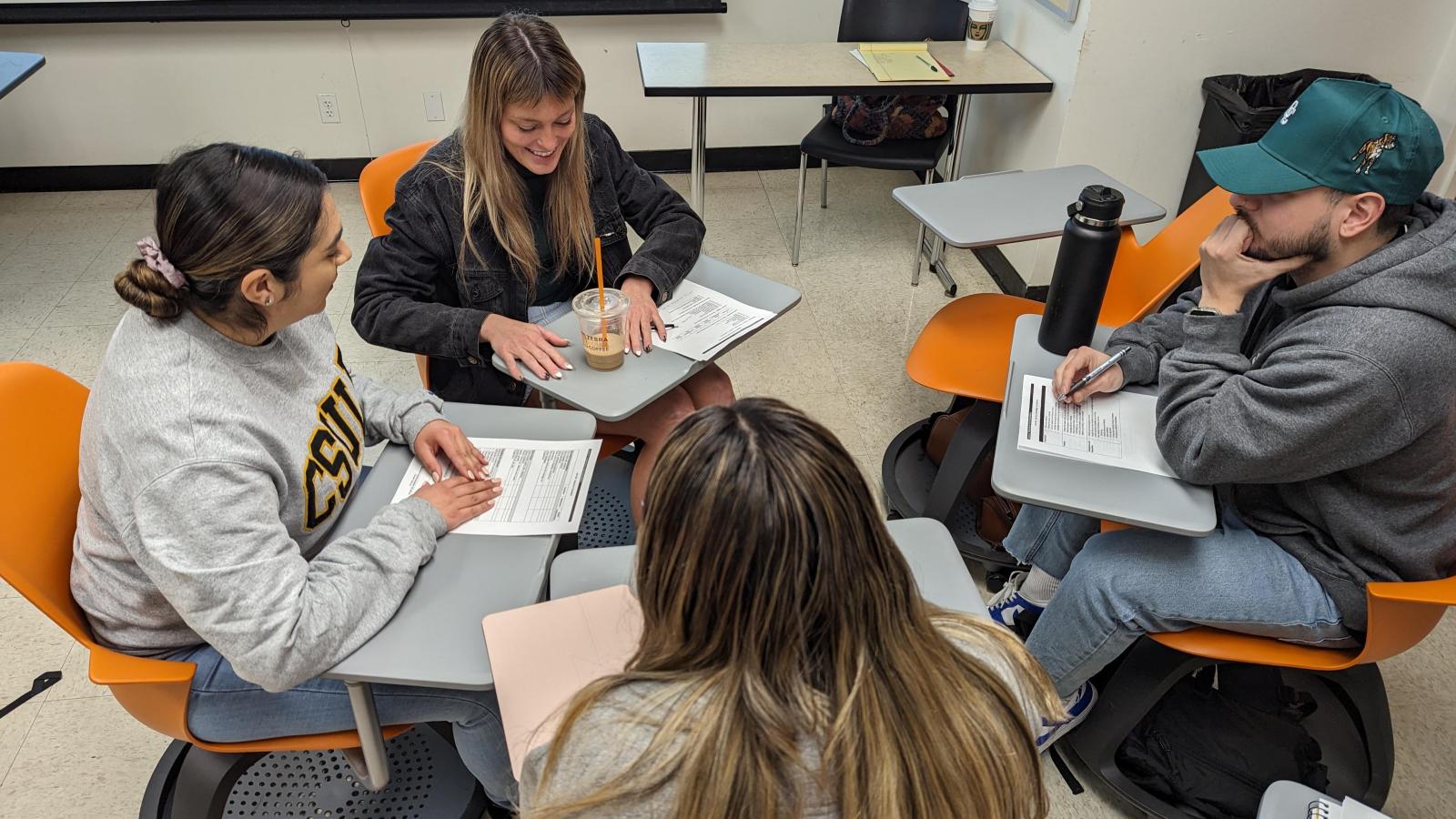 4 students sitting around in a circle