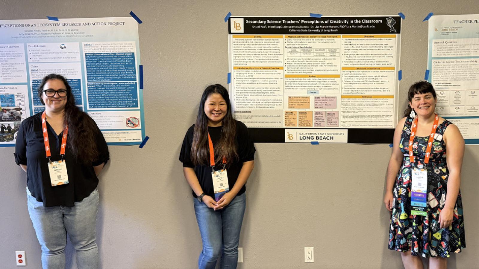 students standing by their research posters