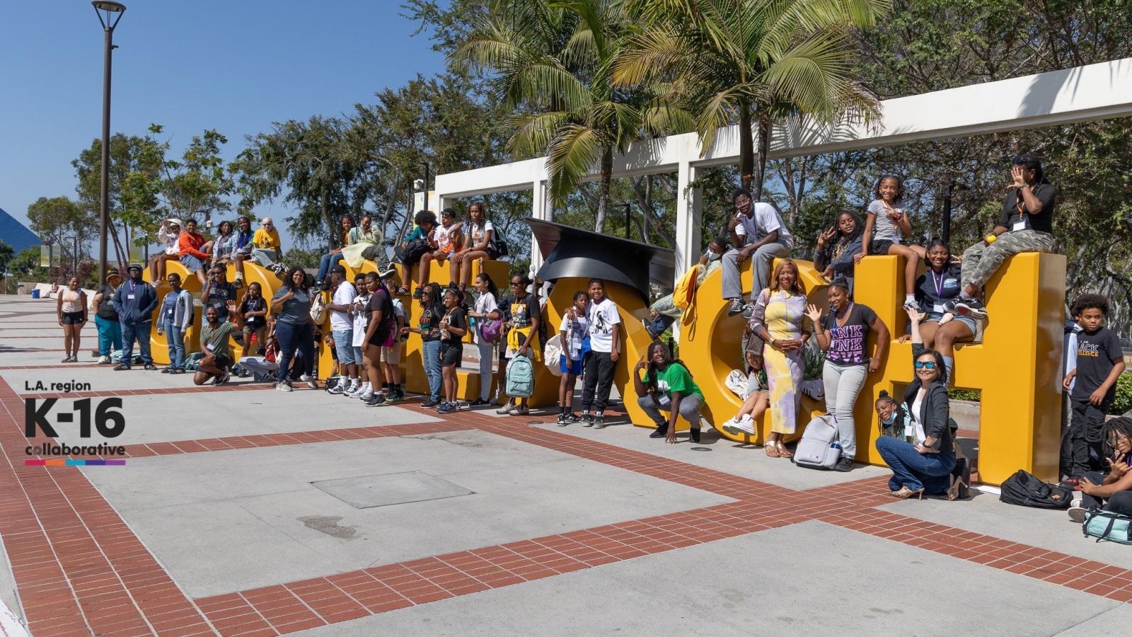 Sankofa students at the Go Beach sign
