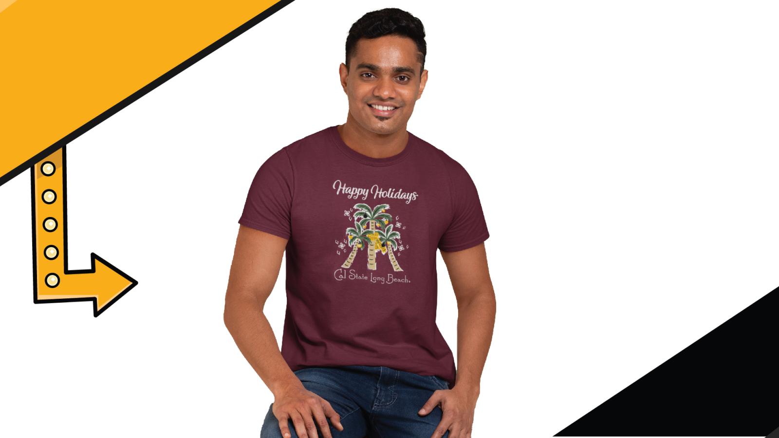Man in a burgundy colored T Shirt with Happy Holidays from Cal State Long Beach on it and features three palm trees decorated like Christmas trees. 