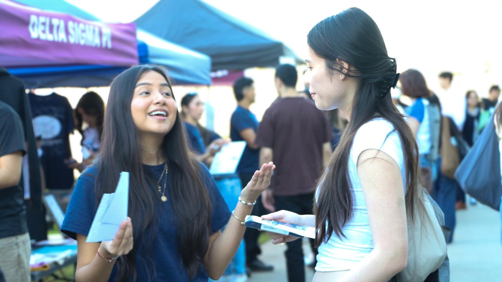 COB CSS get down to business 2026 two females talking at event