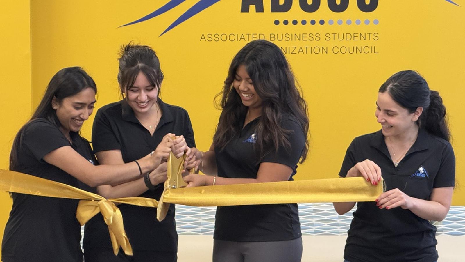 COB ABSOC RIBBON CUTTING 4 girls cutting