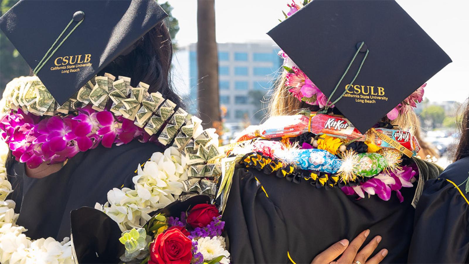 students wearing graduation caps and leis