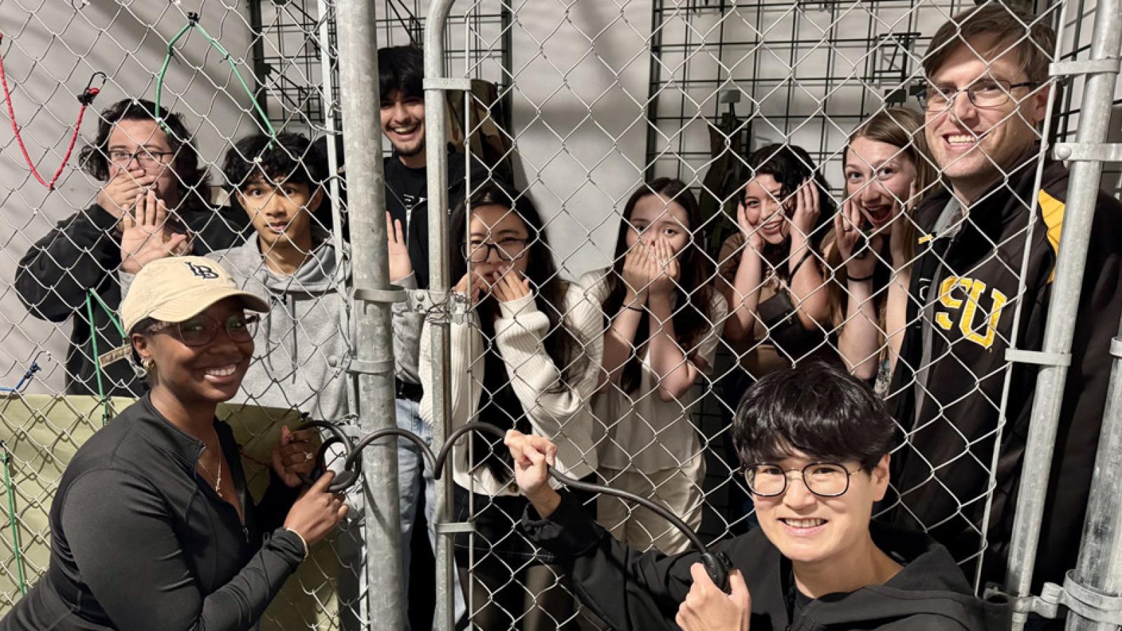 event participants behind a locked gate