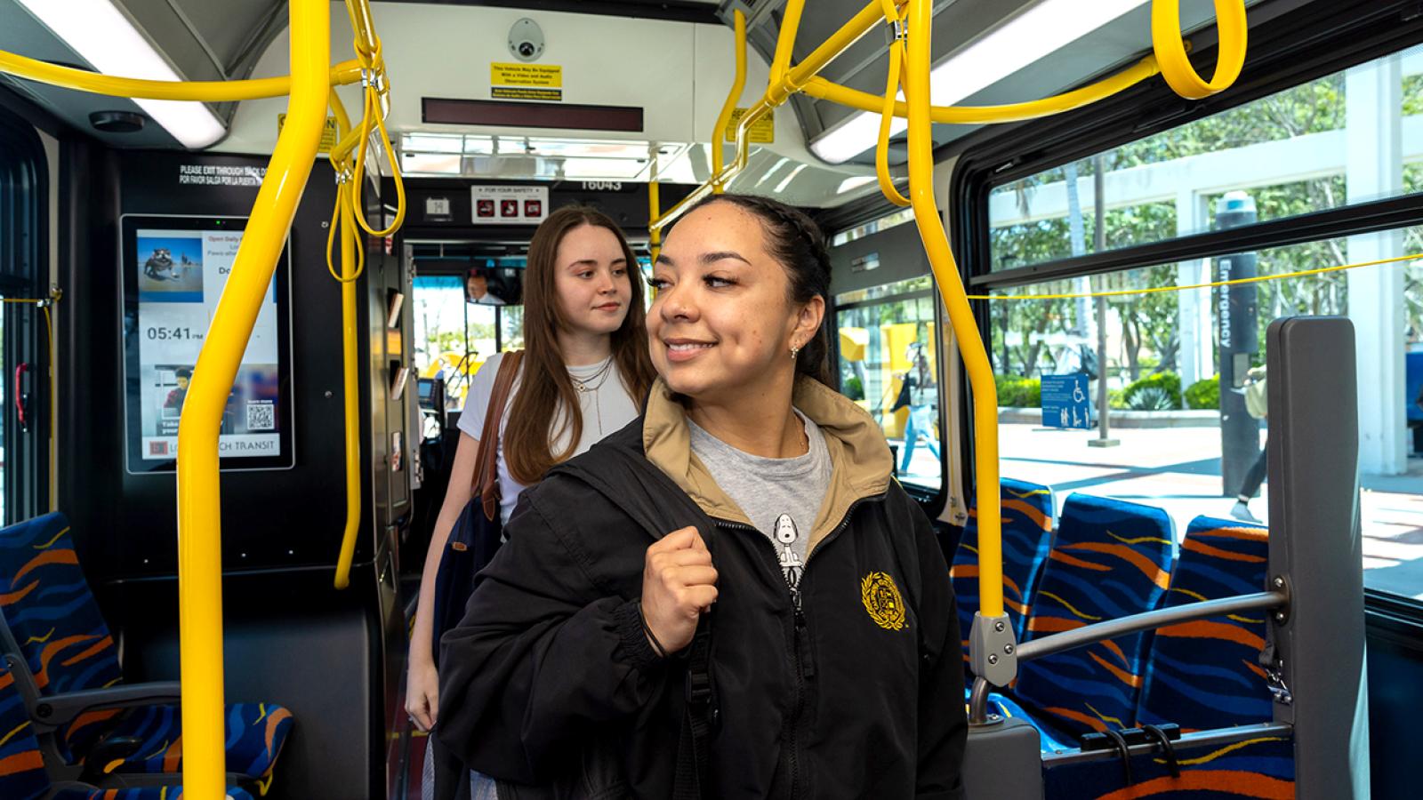 Students walking into a city bus