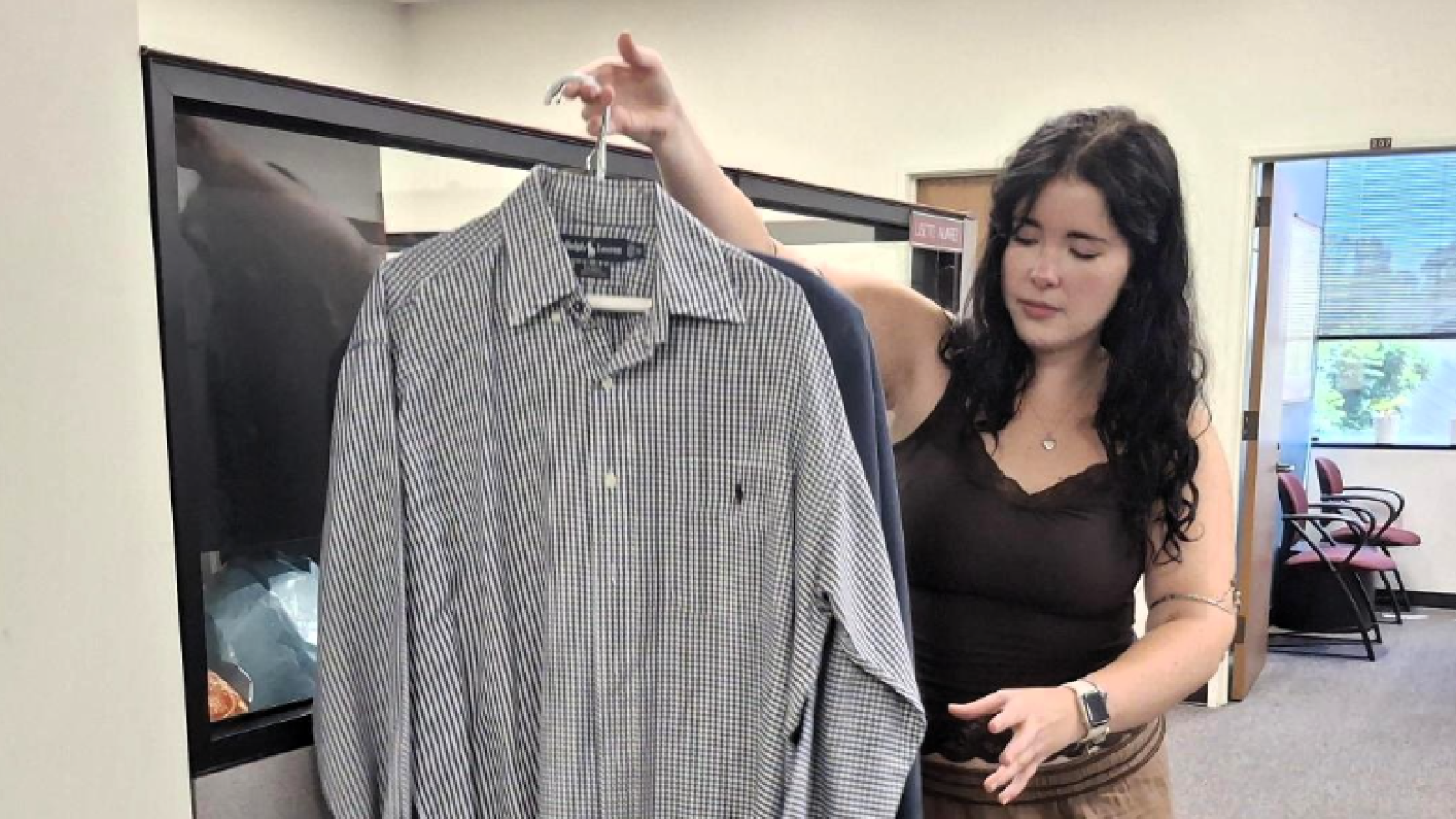 Student lifting donated shirts