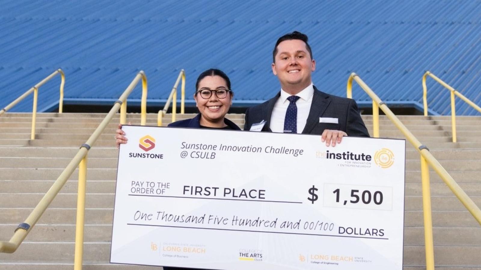 Speek founders Elizabeth Gallegos and Brendan Nelson with their first-place check at the Walter Pyramid