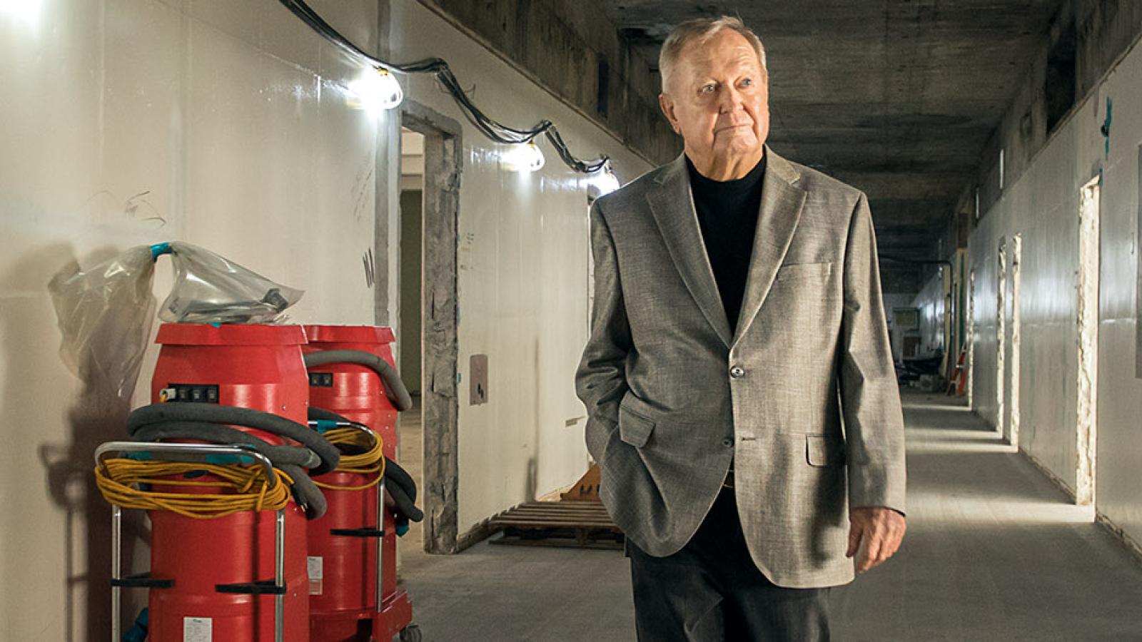 Donor Bob Murphy walks through building under construction