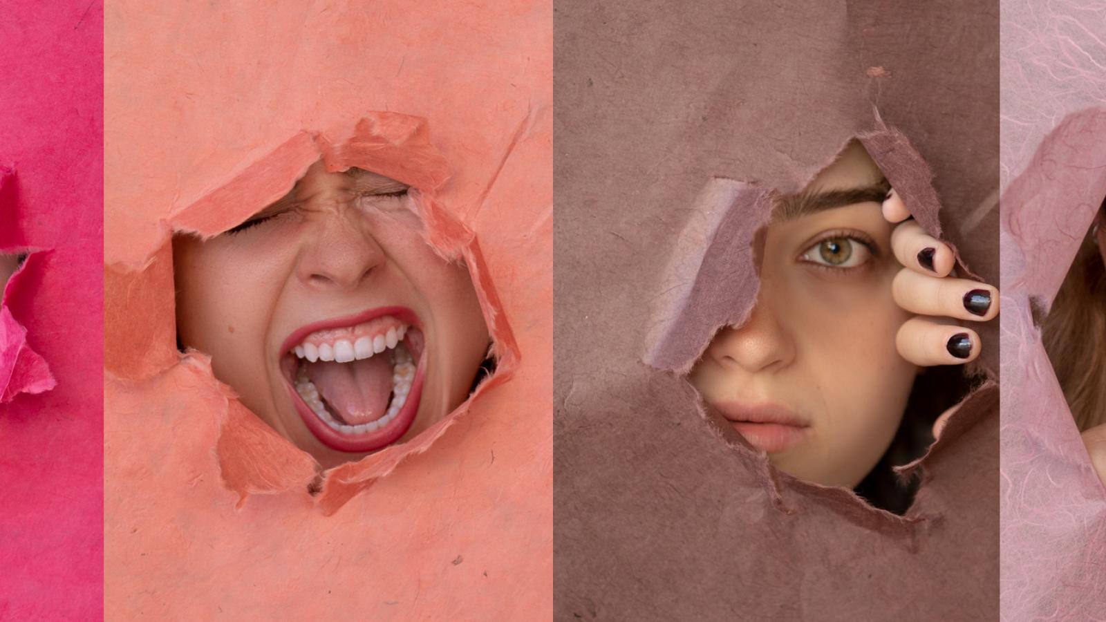 Four pink and brown blocks with female heads revealed in a hole in the paper.