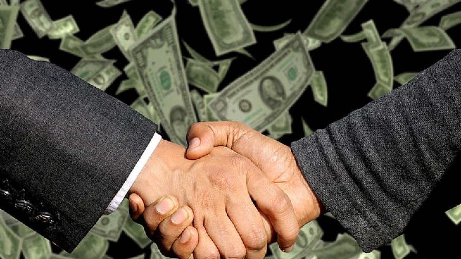 Handshake over Money bills